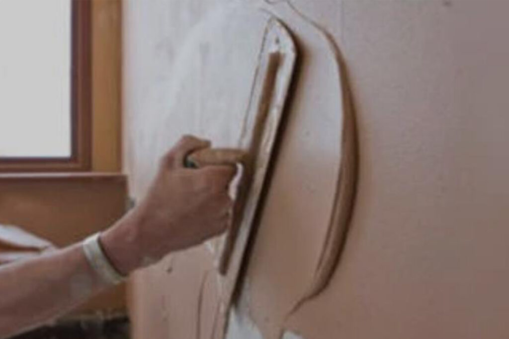 The master plaster the wall. The tool for repair in the apartmen